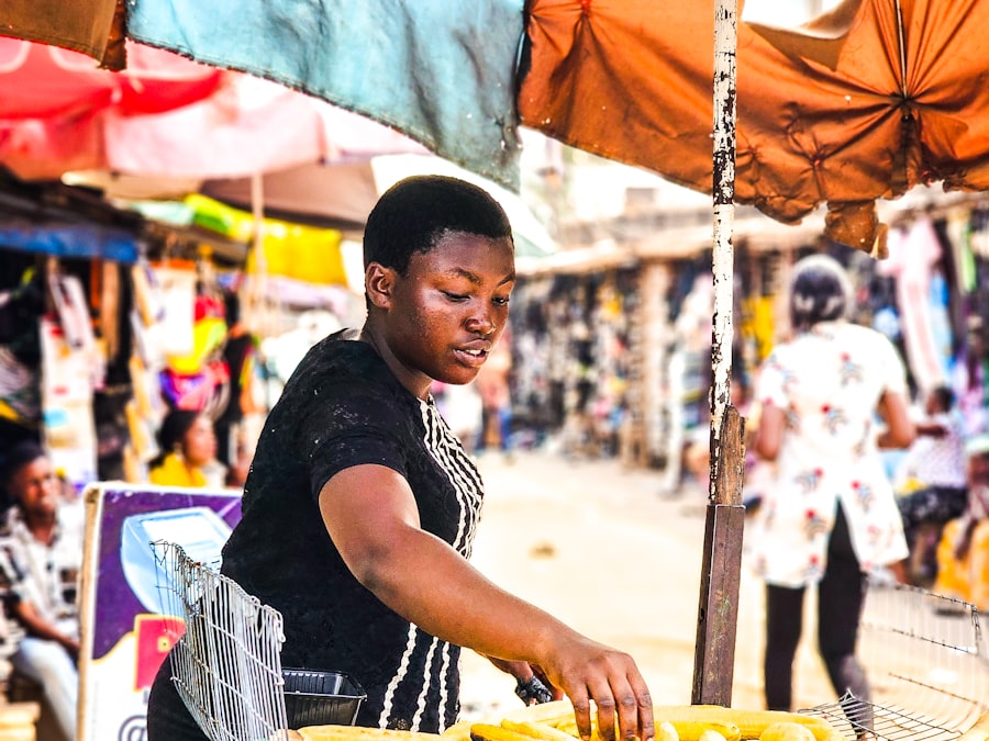 Nigerian vendor preparing grilled plantain at a street food stall
